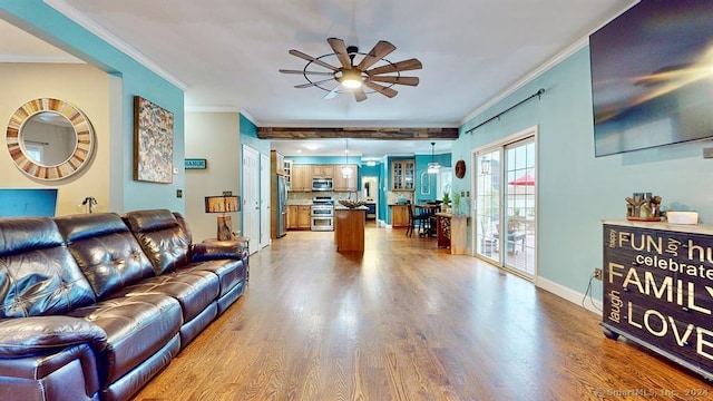 living room featuring ceiling fan, wood-type flooring, and ornamental molding