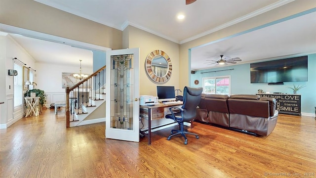 office featuring wood-type flooring, ceiling fan with notable chandelier, and crown molding