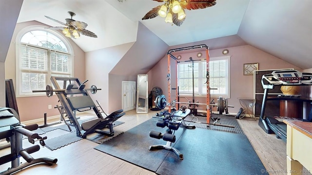 workout room featuring light hardwood / wood-style floors, ceiling fan, and lofted ceiling