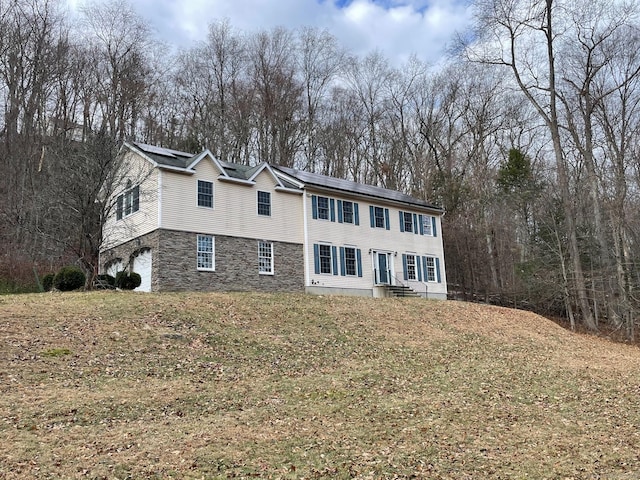 view of front of property with a front lawn and a garage