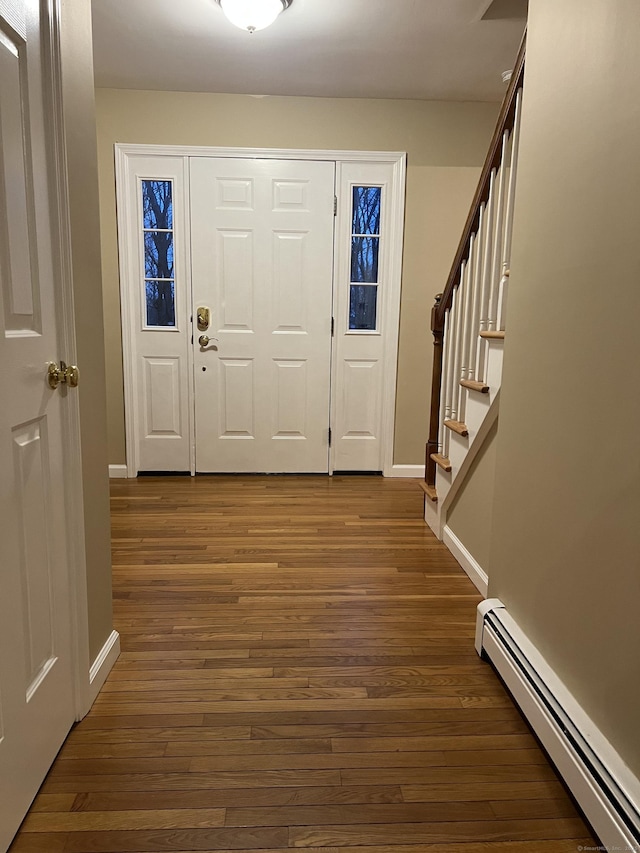 entrance foyer featuring dark hardwood / wood-style floors and a baseboard heating unit