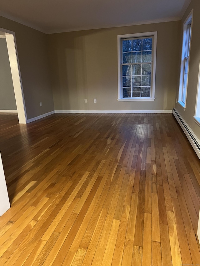 spare room with hardwood / wood-style floors and ornamental molding