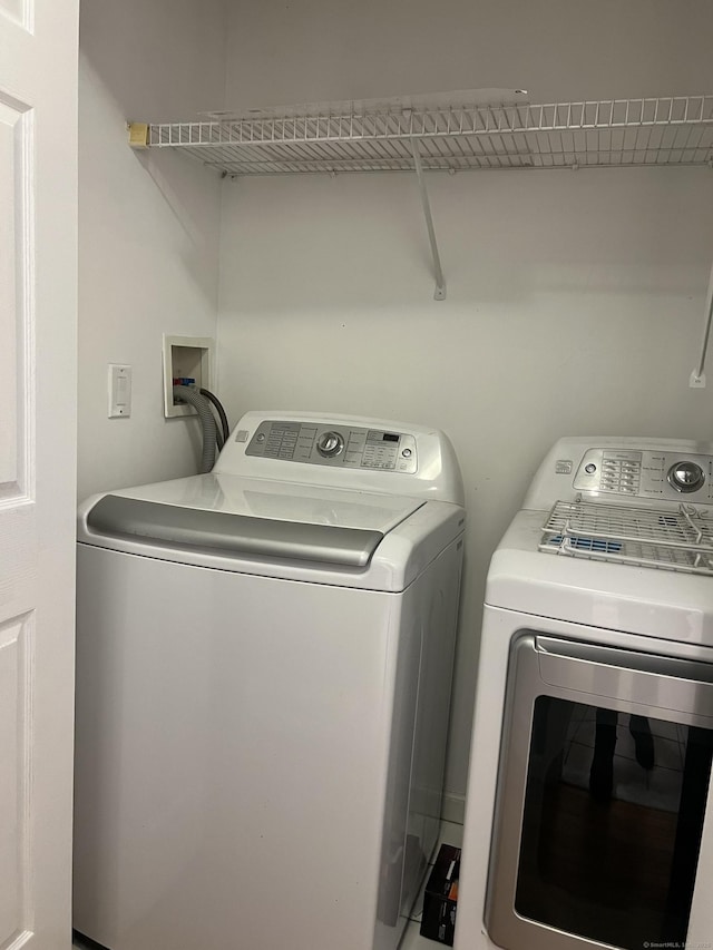 laundry area with separate washer and dryer