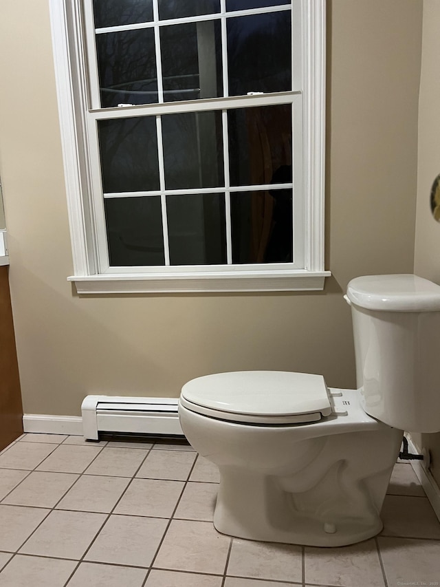 bathroom with toilet, tile patterned flooring, and a baseboard heating unit