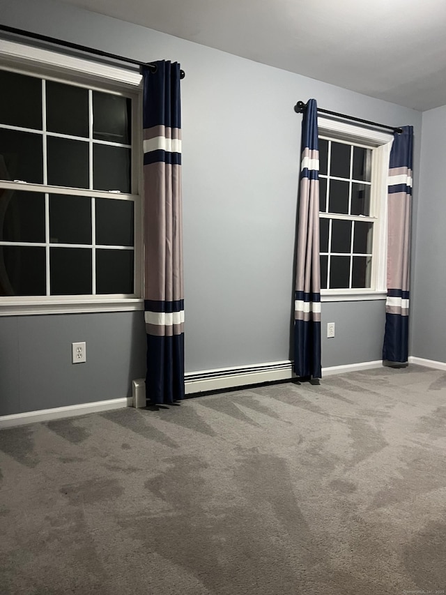 unfurnished room with carpet flooring and a baseboard radiator