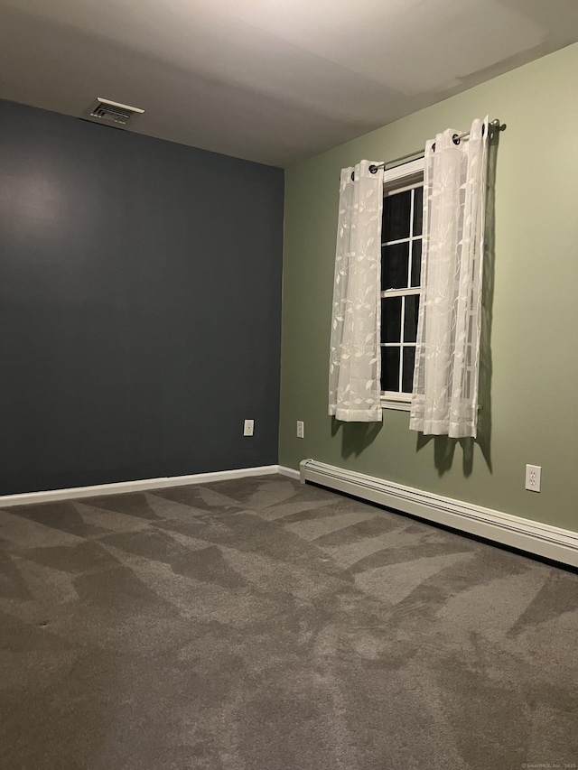 carpeted empty room with a baseboard radiator