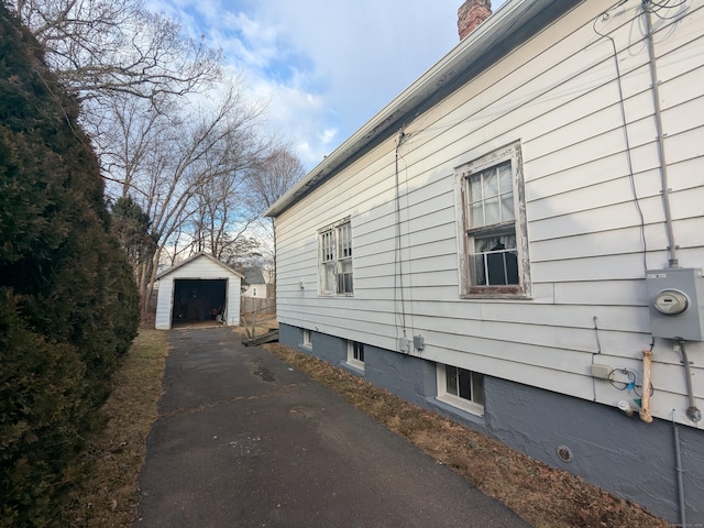 view of side of property with an outbuilding and a garage