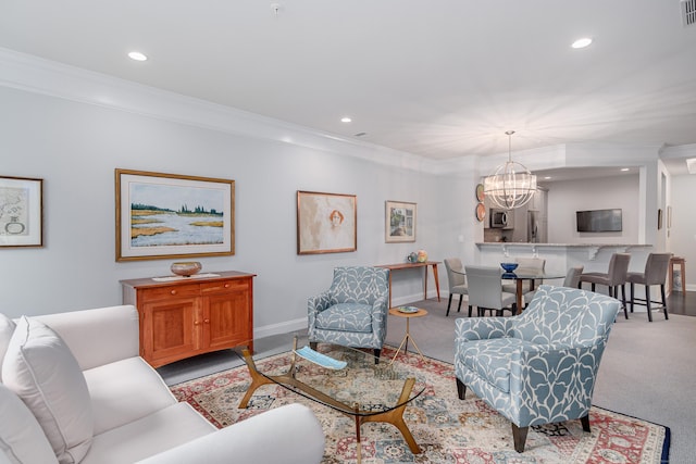 living room featuring light colored carpet, an inviting chandelier, and crown molding