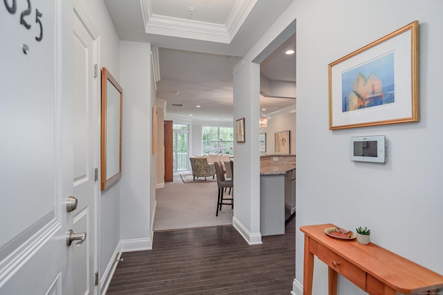 hall with dark hardwood / wood-style flooring and ornamental molding