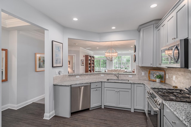 kitchen with dark wood-type flooring, sink, decorative backsplash, appliances with stainless steel finishes, and light stone counters