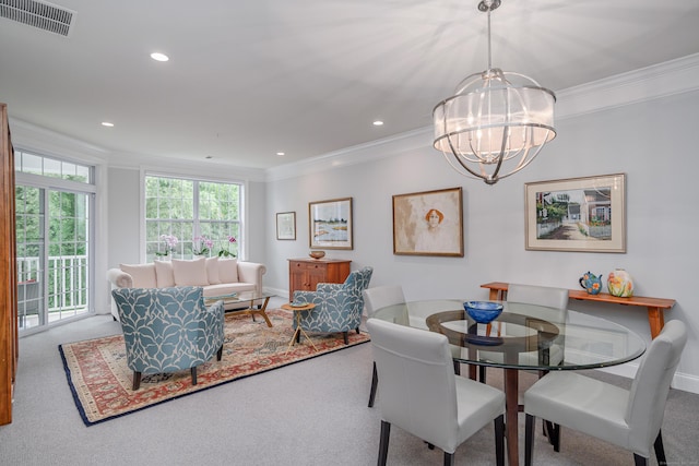 carpeted dining area featuring a notable chandelier and crown molding