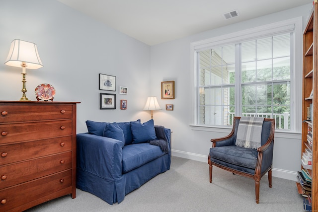 sitting room featuring light colored carpet