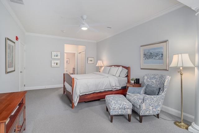 carpeted bedroom with decorative columns, ceiling fan, and ornamental molding