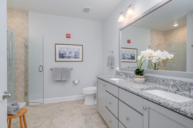 bathroom featuring vanity, an enclosed shower, and toilet