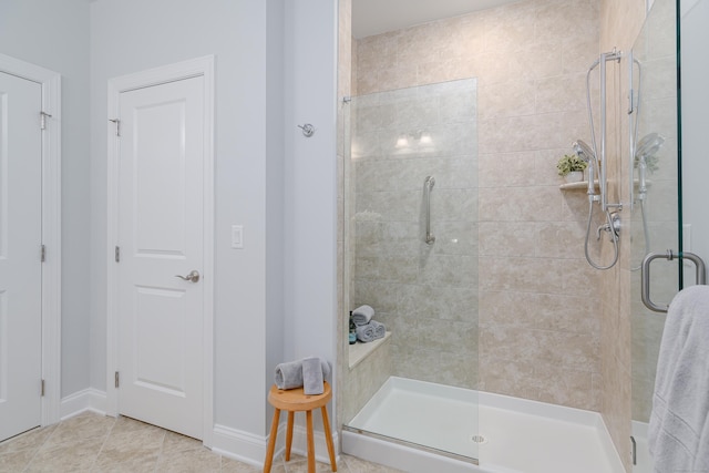 bathroom featuring tile patterned floors and a shower with shower door