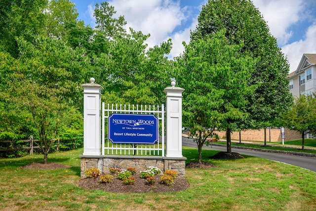 community / neighborhood sign with a yard