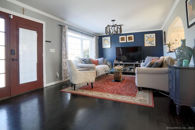 living room with dark wood-type flooring, ornamental molding, and an inviting chandelier