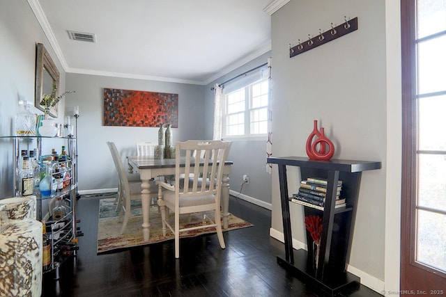 dining room featuring dark hardwood / wood-style flooring and crown molding