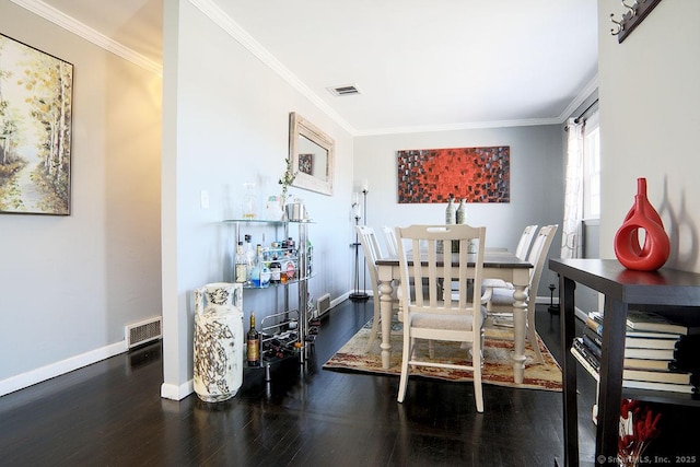 dining area with dark wood-type flooring and ornamental molding