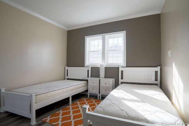 bedroom with dark hardwood / wood-style floors and ornamental molding