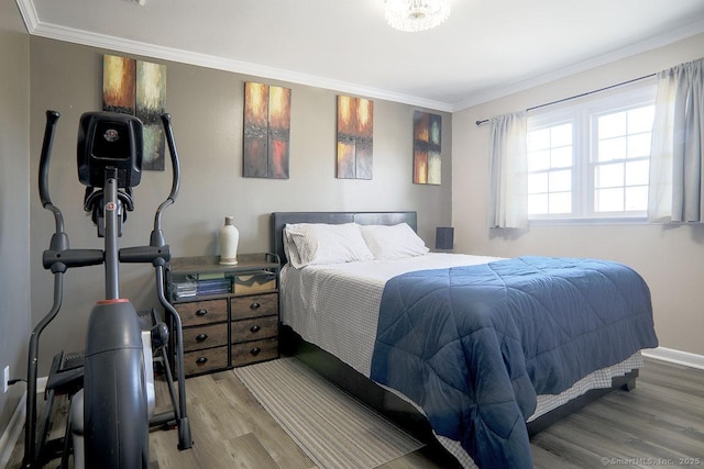 bedroom featuring ornamental molding and hardwood / wood-style floors