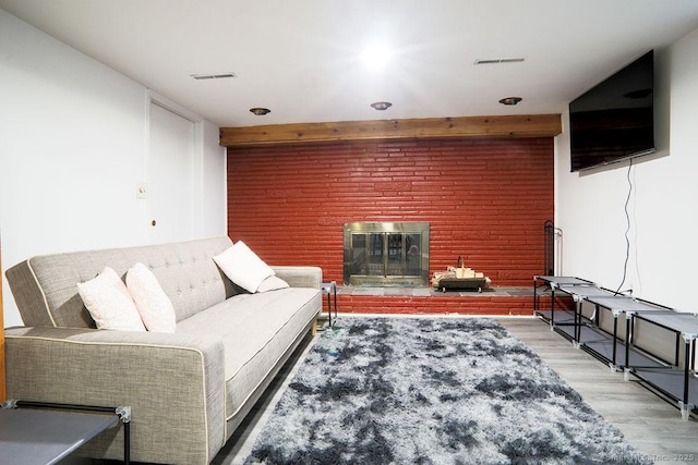 living room with light wood-type flooring and a fireplace