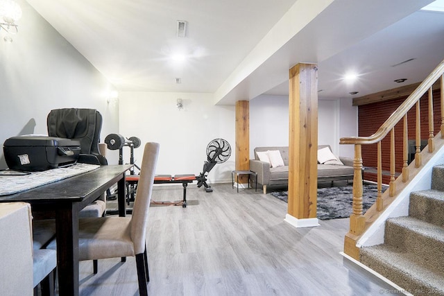 exercise room with light wood-type flooring