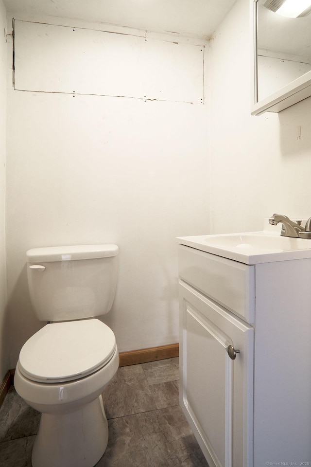 bathroom with toilet and vanity