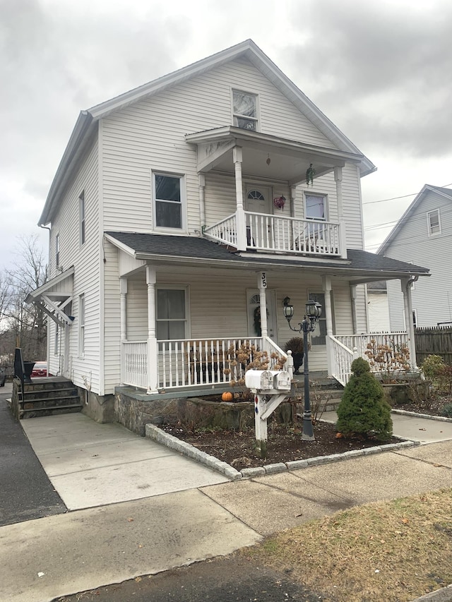 view of front facade featuring a balcony and a porch