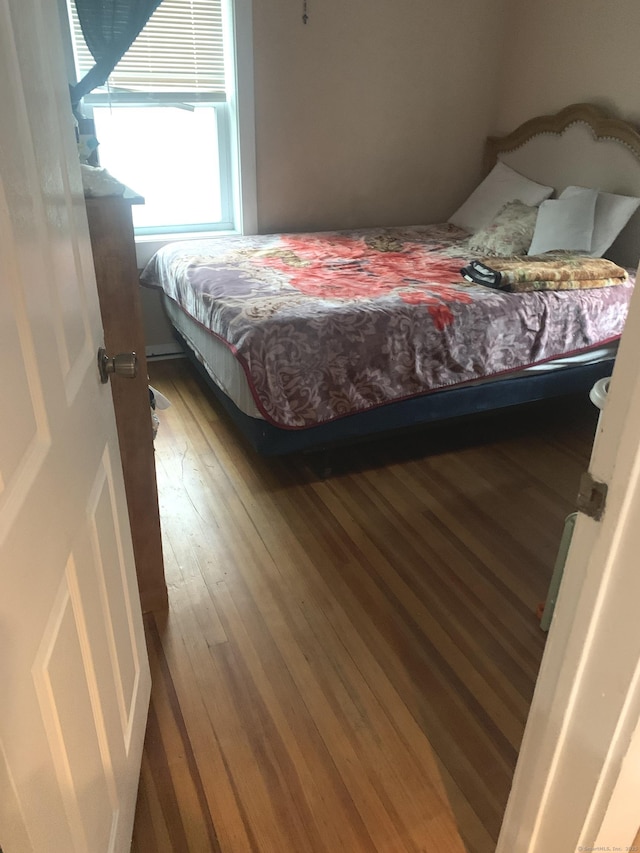 bedroom with hardwood / wood-style floors