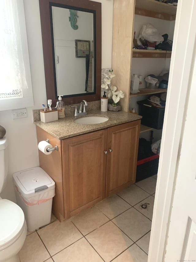 bathroom featuring toilet, vanity, and tile patterned floors