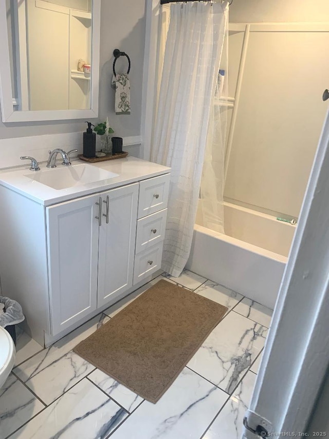 bathroom featuring shower / bath combo and vanity