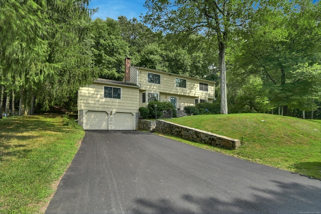 view of front facade with a front yard and a garage