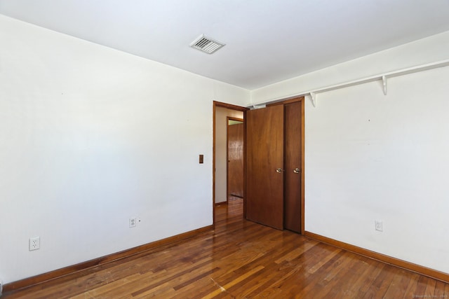 empty room featuring dark hardwood / wood-style flooring