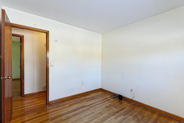 empty room with hardwood / wood-style flooring