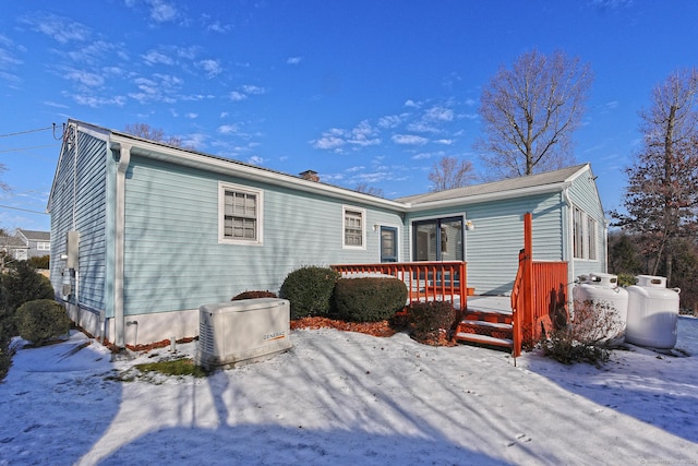 snow covered property featuring a wooden deck