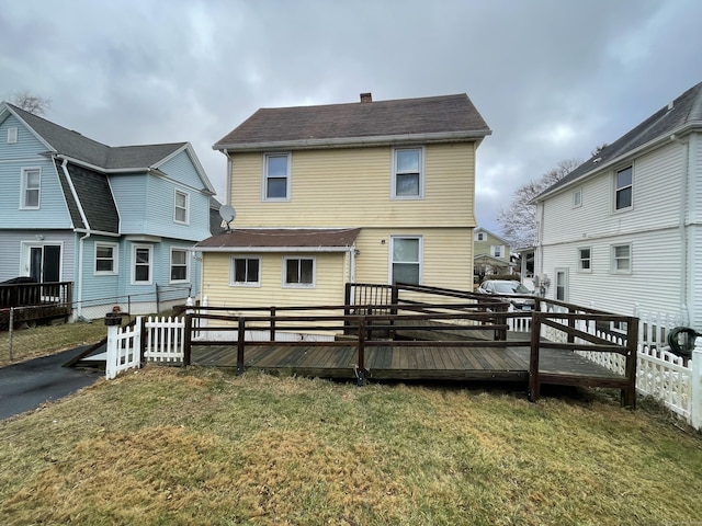 back of house with a yard and a wooden deck