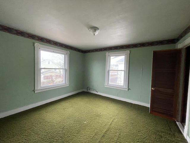 unfurnished room featuring carpet flooring and plenty of natural light