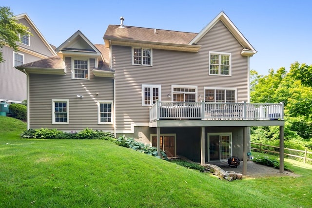 back of house featuring a yard and a deck