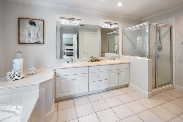 bathroom with tile patterned flooring, crown molding, vanity, and walk in shower