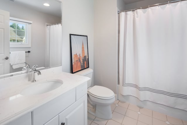 full bathroom featuring vanity, tile patterned floors, shower / bath combo with shower curtain, and toilet