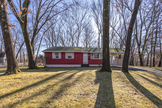 single story home with a front lawn and a carport