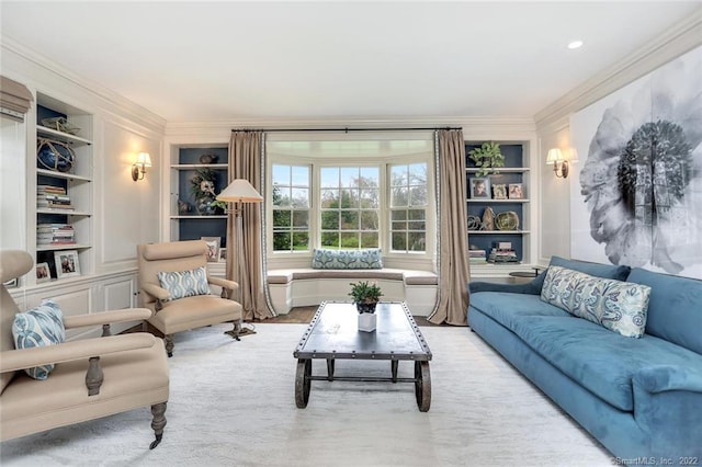 living room with built in features and ornamental molding