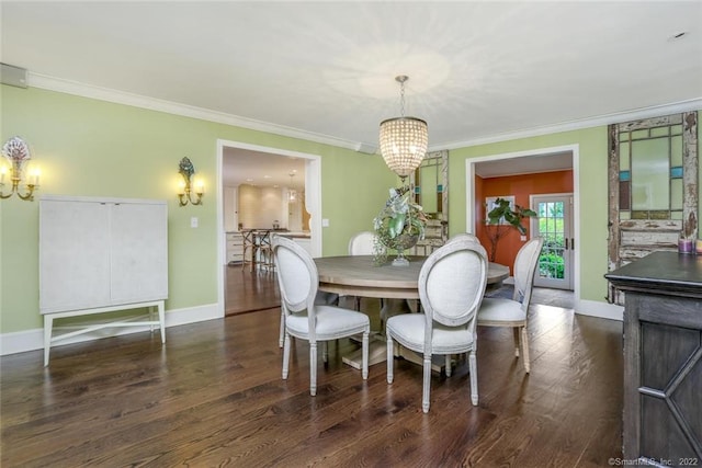 dining space with dark hardwood / wood-style floors, ornamental molding, and a notable chandelier