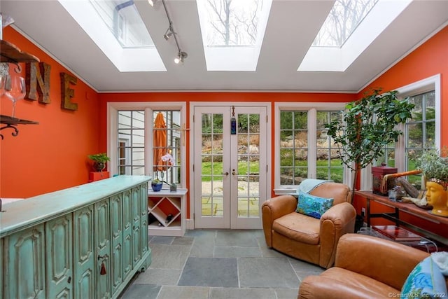 sunroom with french doors and lofted ceiling with skylight