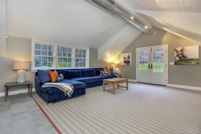 living room with vaulted ceiling with beams, french doors, and track lighting