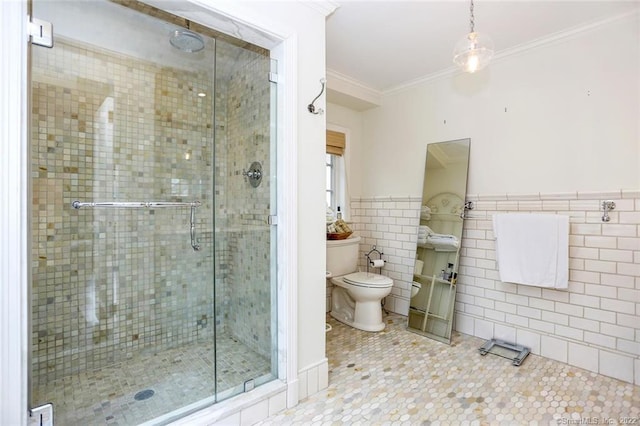 bathroom with tile patterned flooring, toilet, ornamental molding, tile walls, and walk in shower