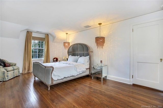 bedroom with dark hardwood / wood-style flooring