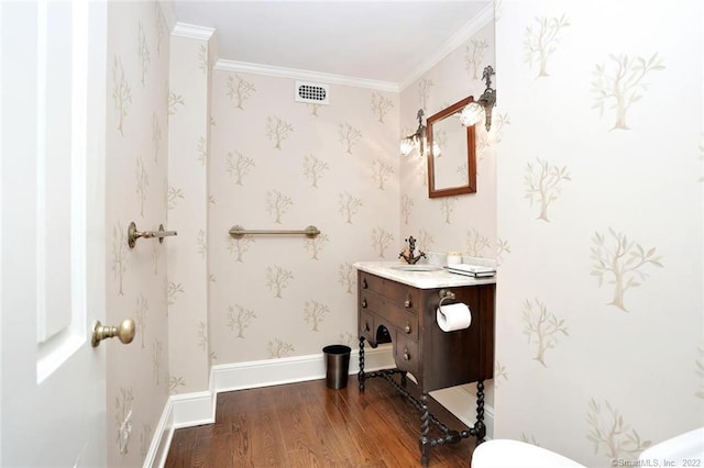 bathroom featuring vanity, hardwood / wood-style flooring, and crown molding