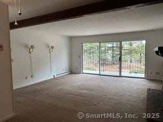 carpeted empty room featuring beamed ceiling